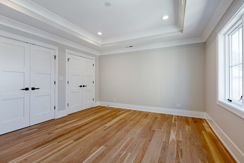 Finished Basement Bedroom With Wood Floors And Double Closets