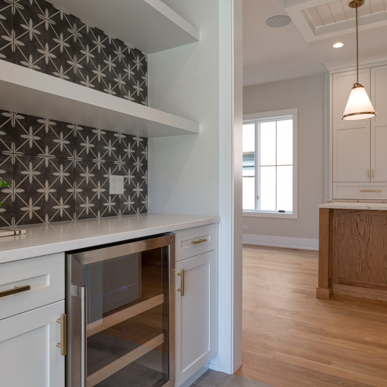 Kitchen Renovation With Black And White Black Splash And Wine Fridge